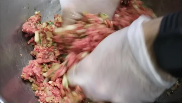 Mix the ground lamb and the mixture thoroughly until well combined.