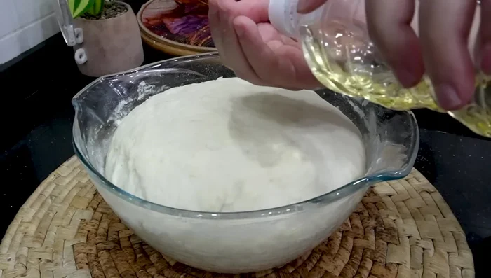 Lightly oil your hands. Divide the risen dough into portions.