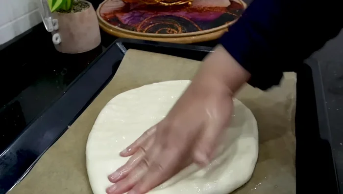 Gently flatten each loaf, then let them rest for 10 minutes to rise again.