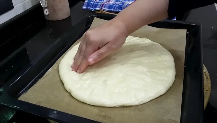 Lightly oil your finger and use it to make indentations on the surface of the loaves.
