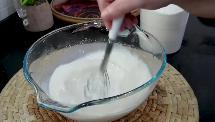 Add salt and gradually incorporate flour until a soft, slightly sticky dough forms. Avoid over-kneading.