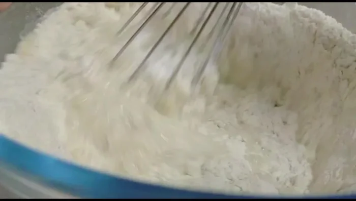 Gradually add water, mixing until a smooth, elastic dough forms. The consistency should be such that when you drop a piece of dough, it falls flawlessly without breaking. This may take 3-5 minutes.