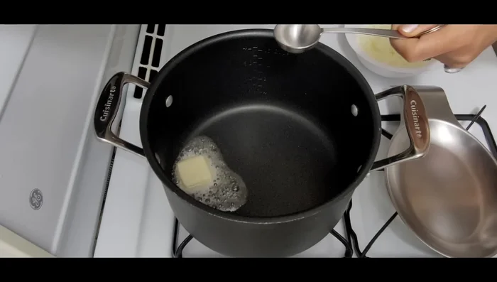 In a pot over medium-high heat, melt butter and olive oil. Add chopped onions and stir until wilted (a few minutes).