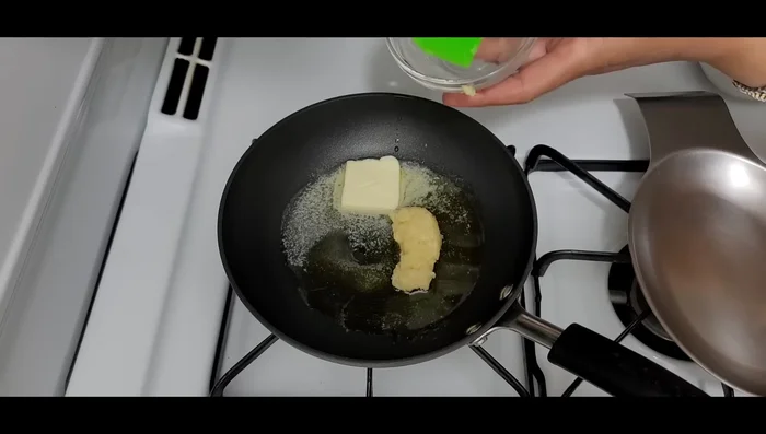 In a frying pan, sauté crushed garlic, olive oil, salt, and chopped coriander until fragrant (about 2 minutes).