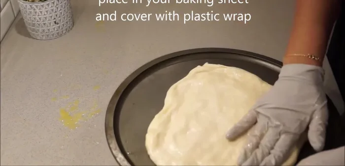 Place the layered dough onto a baking sheet, cover with plastic wrap, and let it rest for 15-30 minutes.