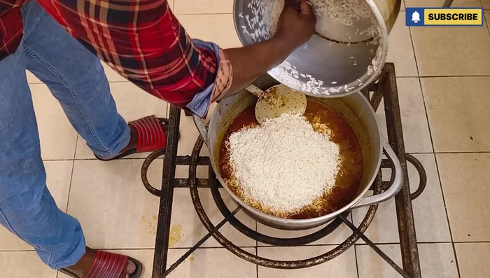 Wash the rice and add it to the pan. Add 3 chilies, salt, and water. Adjust salt as needed. Cook until the rice is done.
