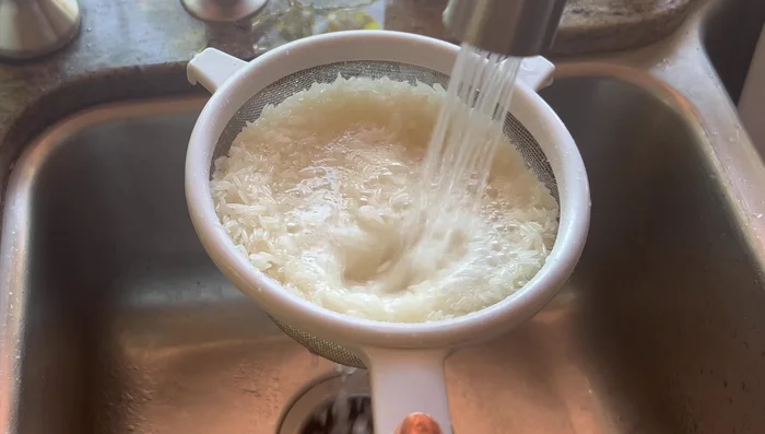 Rinse 2 cups of basmati rice until the water runs clear.
