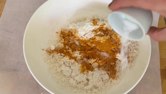 Season the rice with 2 tsp turmeric, 1 tsp salt, and 1 tsp cumin.