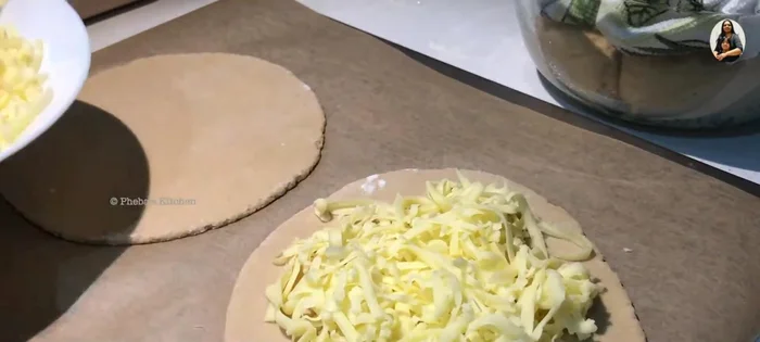 Prepare the Cheese Manakish: Top a disc with cheese, leaving a small edge.
