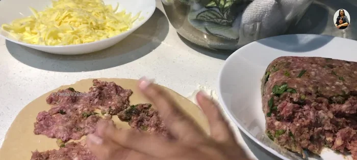 Prepare the Lamb Manakish: Top another disc with lamb mix, leaving a small edge.