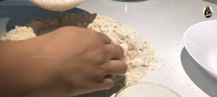 Prepare the dough: In a well of flour, add the yeast mixture, salt, and olive oil. Mix and knead for 5-6 minutes until smooth and elastic.