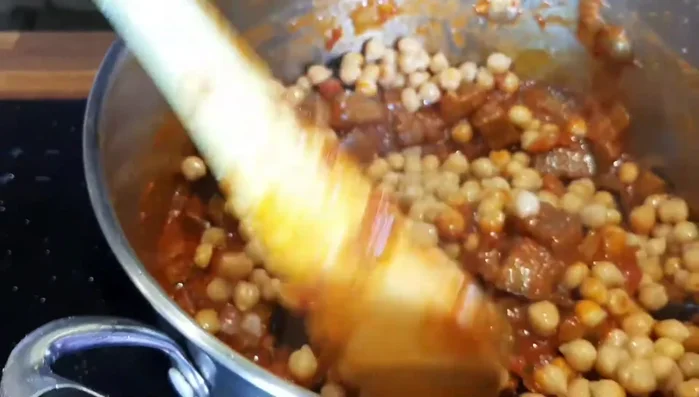 Stir in chickpeas. Bring to a boil, then reduce heat to minimum and simmer for 10-15 minutes, or until eggplant is soft and melting.