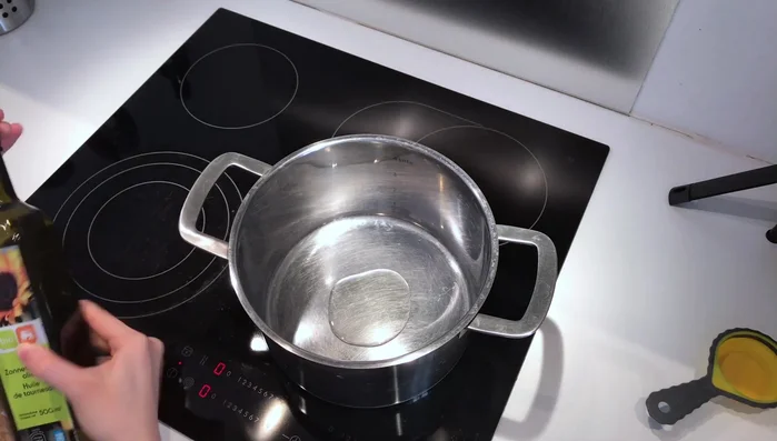Add 1 tablespoon of neutral flavored oil to a pot on medium heat. Add 1/3 cup of pine nuts and fry until golden brown, stirring constantly to prevent burning.