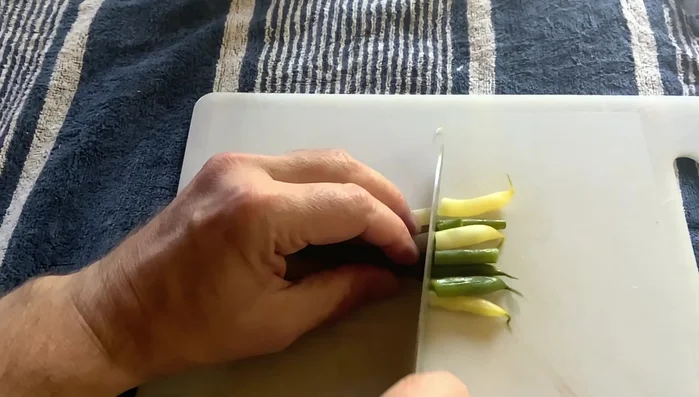 Slice blanched green beans into 3/4 inch lengths.