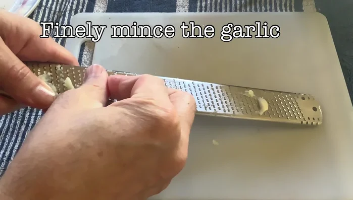 Finely mince garlic into a puree.