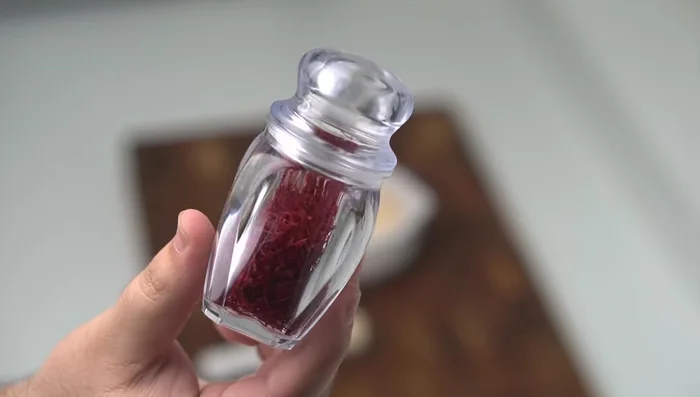 Bloom saffron by grinding it finely with a pinch of salt, then dissolving it in 60ml of hot water.