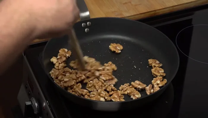 Toast walnuts in a cold pan for about two minutes, then process them into a paste using a food processor or blender.