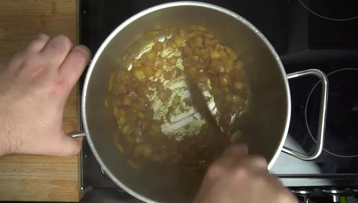 Deglaze the pot with a small amount of water. Add walnut paste and cook, stirring constantly, until oils seep out (about 5 minutes).