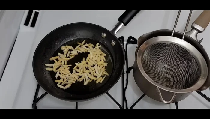 Roast almonds in the same ghee until browned. Drain them in a strainer.