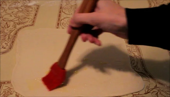 Brush butter on both sides of the dough.