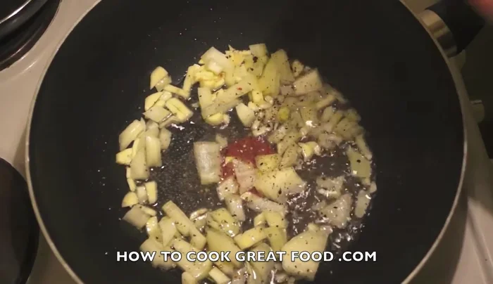 Add chili powder, coriander powder, turmeric powder, dried mint, and cumin powder. Cook until onions soften.