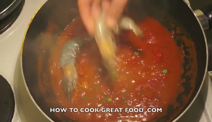 Add cleaned shrimps and cut cod to the sauce. Cook for about 2 minutes.
