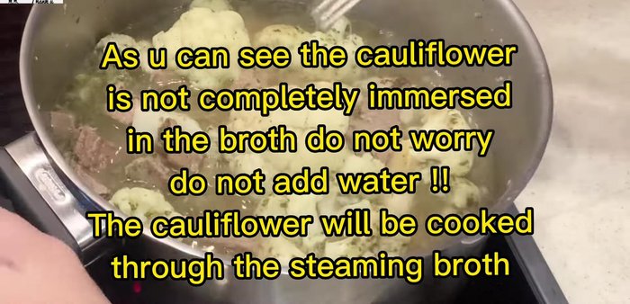Add the cooked meat back to the pot. Gently stir the cauliflower and meat. Cover the pot and cook until the cauliflower is tender.