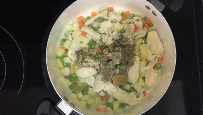 Add the chicken broth cube, salt, and black pepper. Mix well.