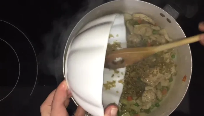 Drain the soaked freekeh and add it to the pot.