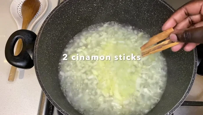 Add two cinnamon sticks and coriander powder.
