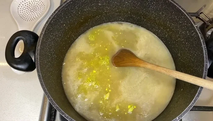 Add vegetable stock powder and cardamom pods.
