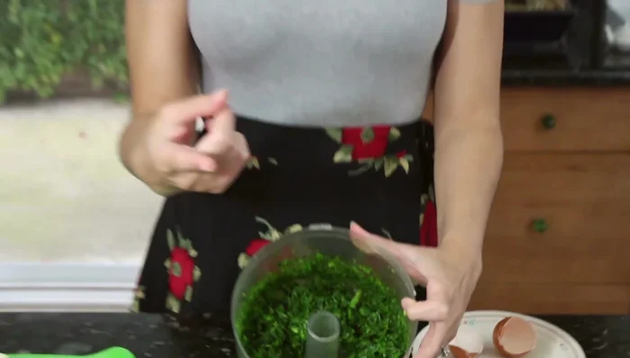 Blend cilantro, leeks (or green onions), and parsley in a food processor.