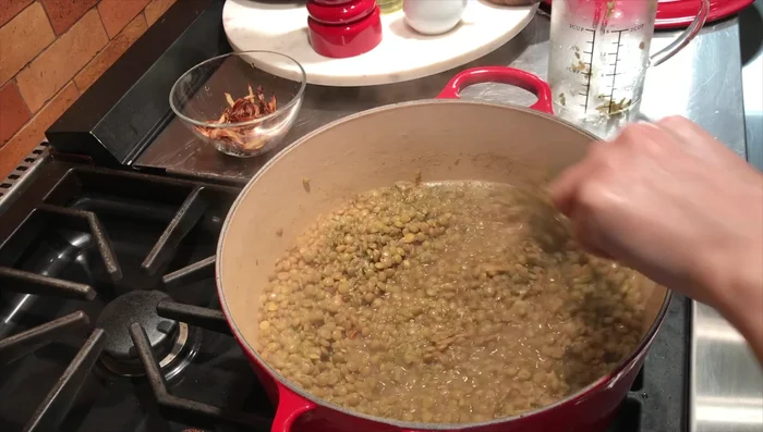 Add the reserved fried onions for garnish. Mix gently, adjust spices as needed, reduce heat to low, cover, and simmer for another 10-15 minutes.