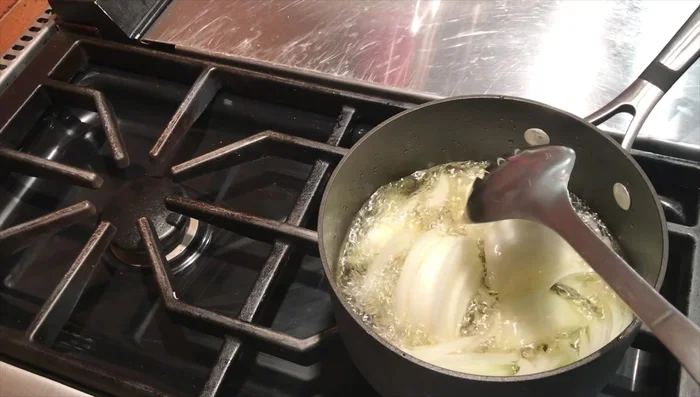 Heat vegetable oil in a frying pan and deep-fry the thinly sliced onions until brownish. This will take some time.