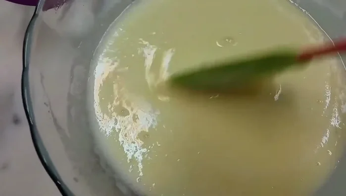 Pour the batter into a greased baking pan.
