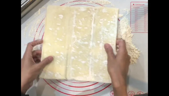 Roll out the puff pastry on a floured surface to 1/4 to 1/8 inch thickness.
