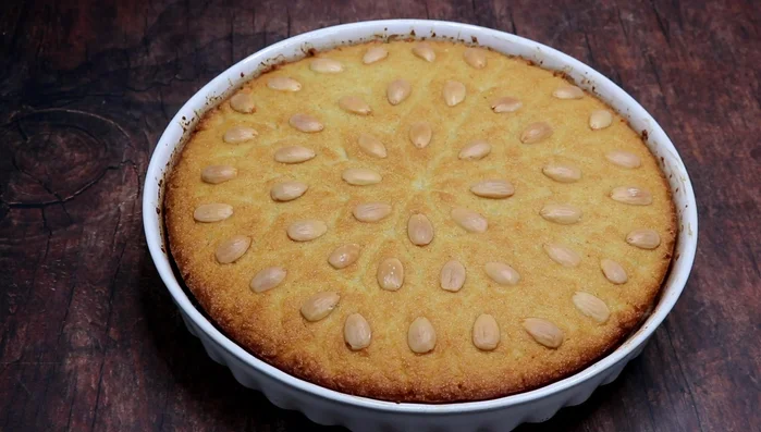 Gently score the baked basboussa to ensure even syrup absorption.
