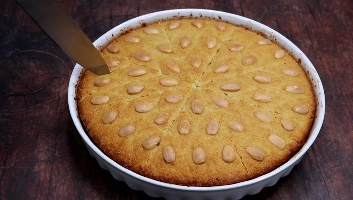 Pour the cooled syrup over the basboussa, allowing it to soak for at least 2-3 hours (or up to 12 hours).