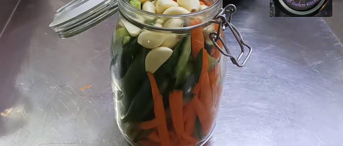 Pour the heated vinegar mixture over the vegetables in the jar.