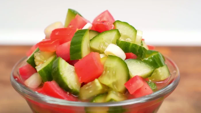 Chop cucumbers and tomatoes into cubes (approx. ½ cm). Add to a bowl.