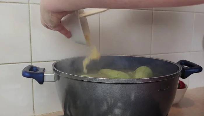 Add crushed garlic and salt to the saucepan. Continue to cook until zucchinis are tender.