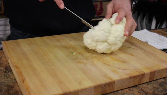 Separate the cauliflower florets and cut them into bite-sized pieces.