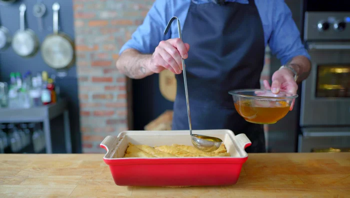Strain the solids from the cooled syrup. Pour syrup over the hot baklava, ensuring it gets into the cracks between pieces.