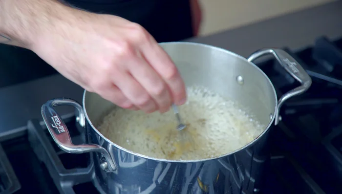 Add lemon slices and cinnamon sticks to the syrup. Let cool for about an hour.