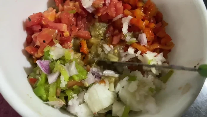 **Baba Ganoush:** Combine roasted eggplant, chopped bell pepper, tomato, green chili, and onion in a bowl. Add cumin powder, salt, paprika powder, garlic paste, lemon juice, freshly crushed black pepper, and olive oil. Mix well.