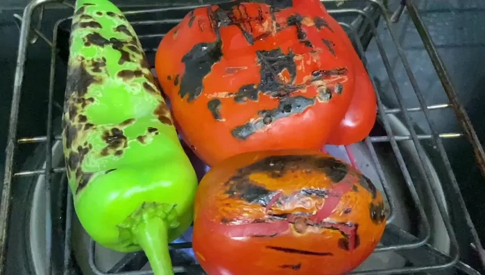 Roast green chili, bell pepper, and tomatoes until charred. Let them rest for five minutes, then peel off the skin and remove seeds.