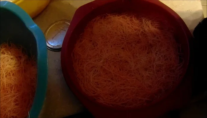 Spread the grated cheese evenly over the dough layer, avoiding the edges to prevent burning.