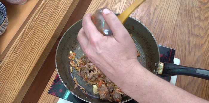 Stir in the tomato paste and cook on a lively heat for about 5 minutes, until the paste darkens and slightly thickens.