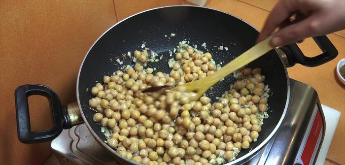 Add chickpeas (rinsed if from a can), cumin powder, salt, and pepper. Cook for 2-3 minutes.