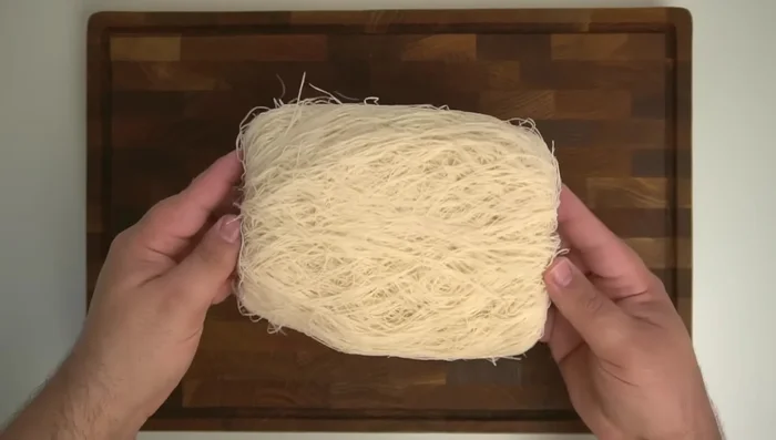 Shred 200g of low-moisture mozzarella.